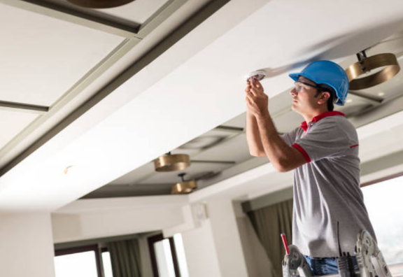 Man installing lights indoors