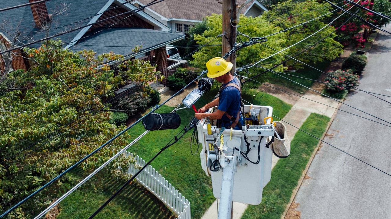 Man repairing electrical wires outdoor